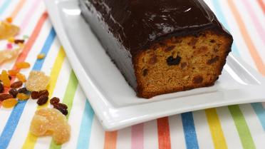 Gembercake met gekonfijt fruit, overgoten met chocolade ganache